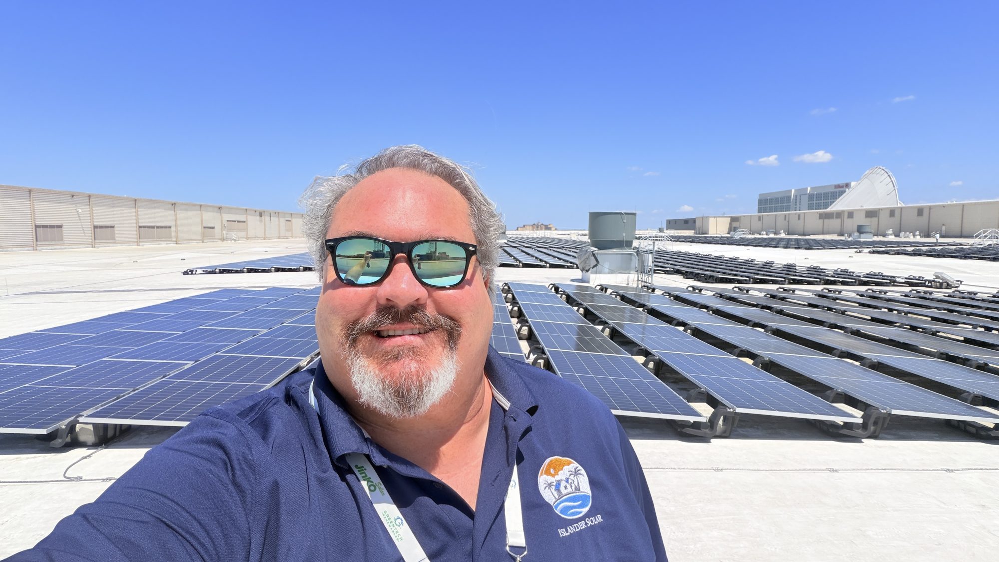 John M. Henry, founder of Islander Solar, on a large commercial rooftop solar array